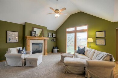 Living Room with Vaulted Ceiling, Fireplace, and T