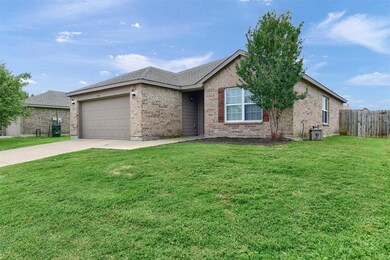 Ranch-style home featuring a front lawn and a garage