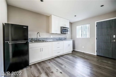 Kitchen with freestanding refrigerator, stainless