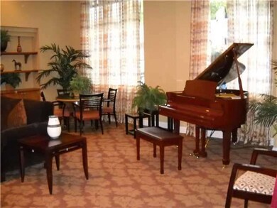 A baby grand piano highlights the common living ro