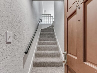 Stairs featuring a textured wall