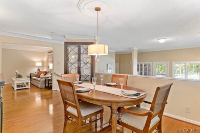 Elegant dining room with hardwood floor off the ki