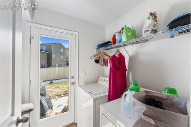 Laundry area featuring washing machine and clothes