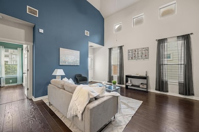 Living area with high vaulted ceiling, baseboards