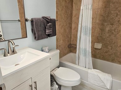 Full bath featuring shower / bath combo and vanity