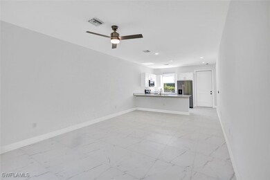 Unfurnished living room featuring marble finish fl