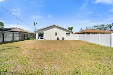 Back of house with a lawn