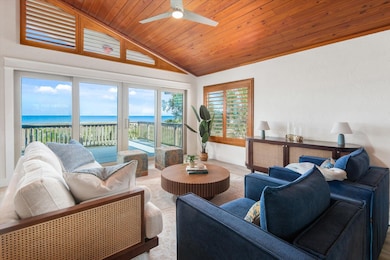 Living room featuring a water view, vaulted ceiling, wooden ceiling, wood finished floors, and ceiling fan