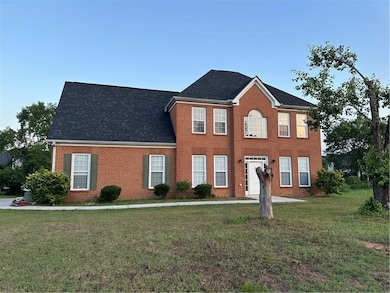 Colonial inspired home with a front lawn