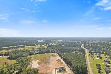 Aerial view of property and surrounding area featuring a heavily wooded area