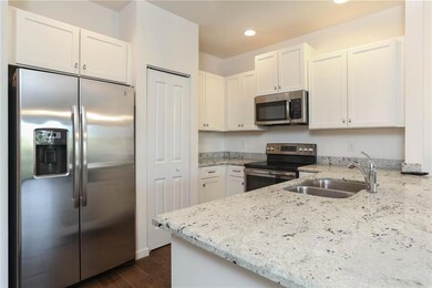 Gorgeous kitchen with granite counter tops, beautiful white cabinets and GE stainless steel appliances