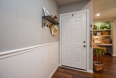 ENTRY TO CONDO WITH LAMINATE WOOD FLOORING THROUGH