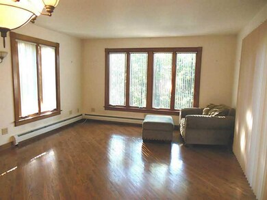 Living Room. Bright and inviting living space with beautiful hardwood floors. Extra large windows allow for natural light.