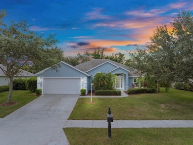 Single story home featuring driveway, a front yard, and stucco siding