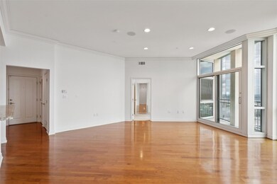 Spare room featuring ornamental molding and hardwo