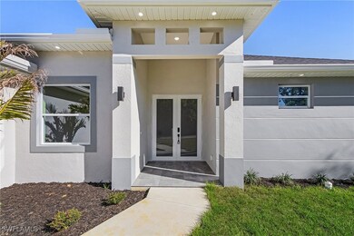 Entrance to property with french doors and stucco