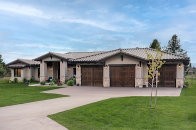 View of front of home featuring stone siding, stucco siding, a garage, concrete driveway, and a tiled roof