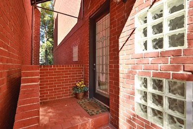 Beautiful brick front porch with wood and glass front door welcomes you and your guests to your home.