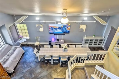 Dining room with baseboards and a textured ceiling