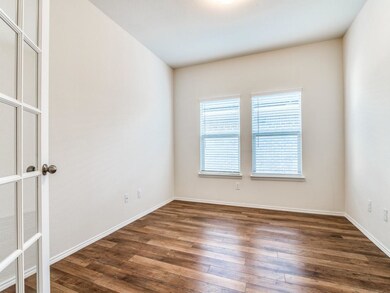 Designated Study with French Doors and Laminate Wood Floors