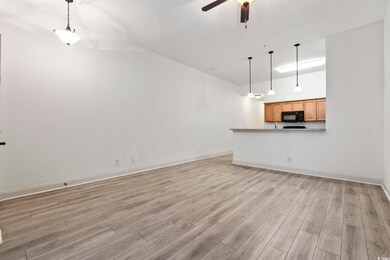 Unfurnished living room featuring light wood-style flooring and ceiling fan