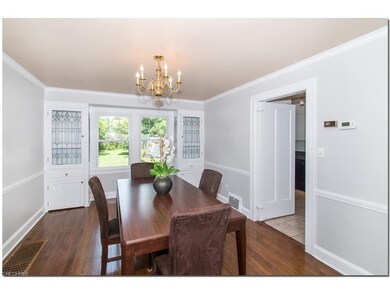 Dining room with oak floors, crown mouldings, lead