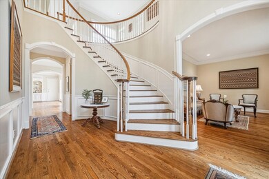 The gracious entry foyer opens to the living room