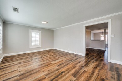 Spare room with visible vents, baseboards, hardwoo