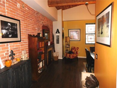 Entry Foyer with brick walls,  exposed beams and w