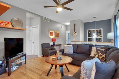 Living room with bamboo flooring, modern lighting and wonderful natural light.