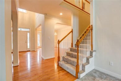 Foyer - Two-story entry, Palladian window above door (not shown here), hardwood floors, front door with sidelights and transom.