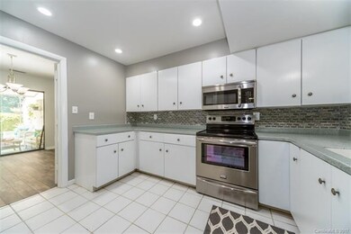Kitchen Area With New SS Appliances and Back Splas
