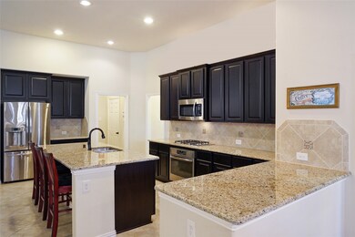 The kitchen also boasts a side island, a great place to serve family style dinners or another prep station for appetizers or dessert.