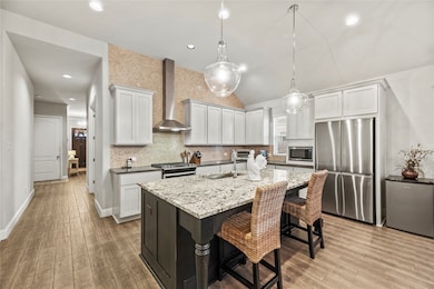 Gorgeous island kitchen with white cabinetry, tile