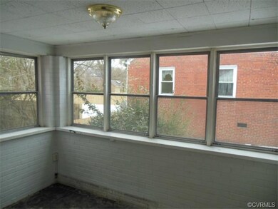 Upon opening the front door, you'll be greeted by this sunroom.  Add some carpet or wood flooring and fresh paint, to transform this inviting space into a nice lounging area.