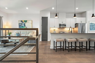 Kitchen with tasteful backsplash, dark countertop