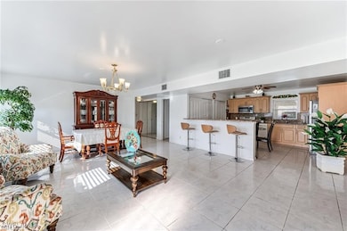 Living area with a chandelier, light tile patterne