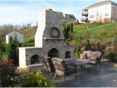 Exterior Back. The outdoor fireplace and patio are