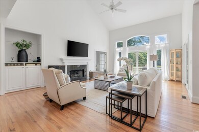 Living room with high vaulted ceiling, a fireplace