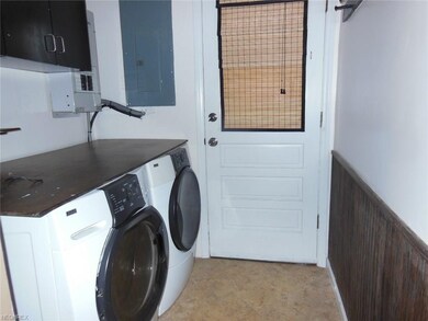 Laundry room just off the kitchen has a door to th