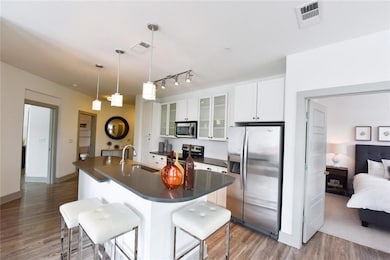 Kitchen with white cabinets, hardwood / wood-style