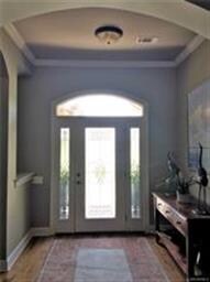 Large foyer with wood floors and arched doorways!