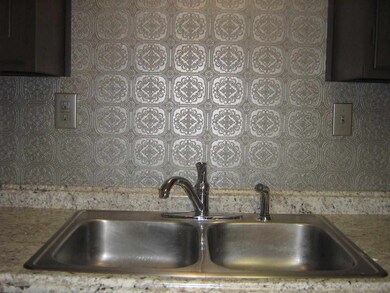 Newer kitchen sink.  Notice the new silver colored