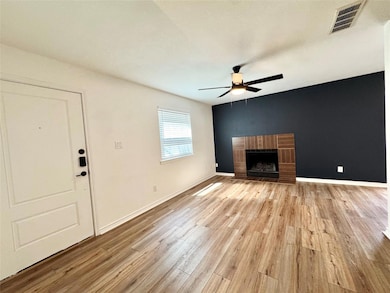 Unfurnished living room featuring ceiling fan, li