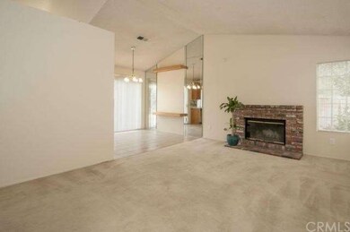 Enter Living room with cozy fireplace.  All window