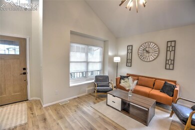 Living room featuring a chandelier, light wood-typ