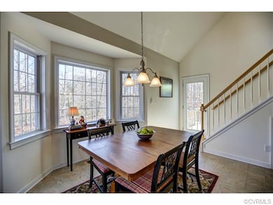 The eat-in area overlooks the wooded backyard and 