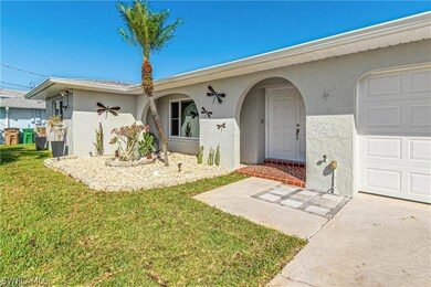 Single story home with a garage and a front lawn