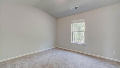 Empty room featuring light carpet and vaulted ceil