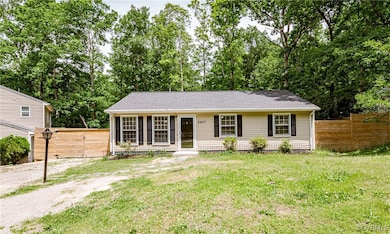 View of front of home with roof with shingles, a g